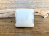Square natural white stone and brass knob