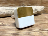 Square natural white stone and brass knob